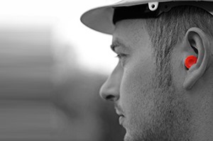 A man's side profile showing hearing protection in his ear